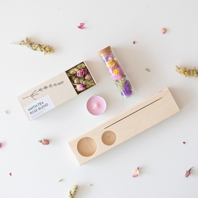 Houten plankje met kaarsje en buisje met droogbloemen. Er is ruimte voor een kaart in het plankje