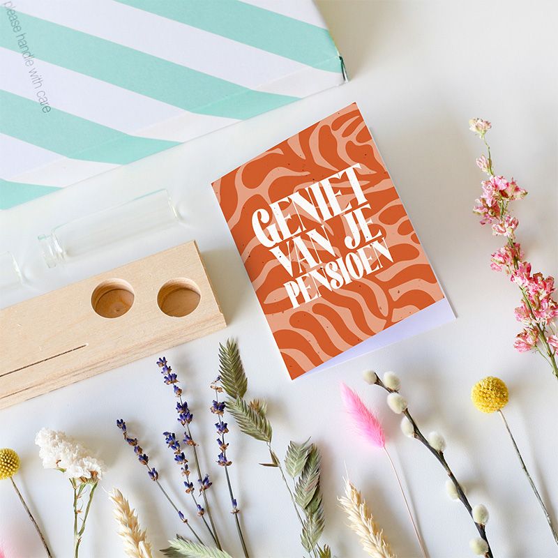 Brievenbus droogbloemen in verschillende kleuren in twee vaasjes op een plankje