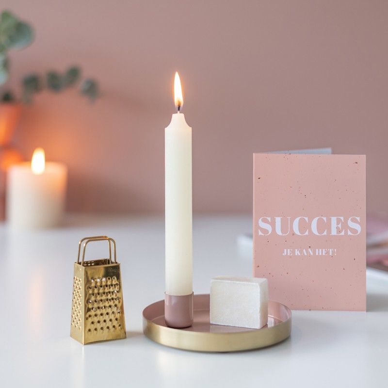 Roze goud schaaltje met een kaars en een amberblokje met daarnaast een gouden rasp