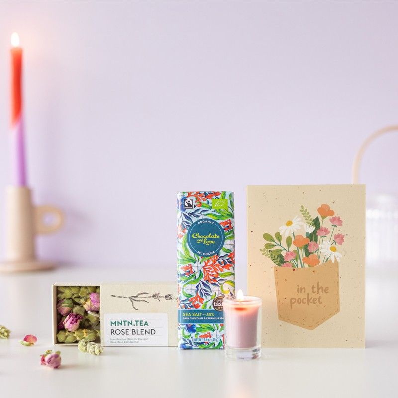 Brievenbuspakketje met een doosje rozen thee, chocolade puur zeezout en een mini roze kaars