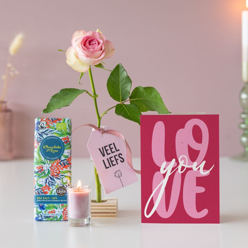Veel liefs pakketje met een roze roos, roze kaarsje in vaasje en een puur zeezout chocoladereep 